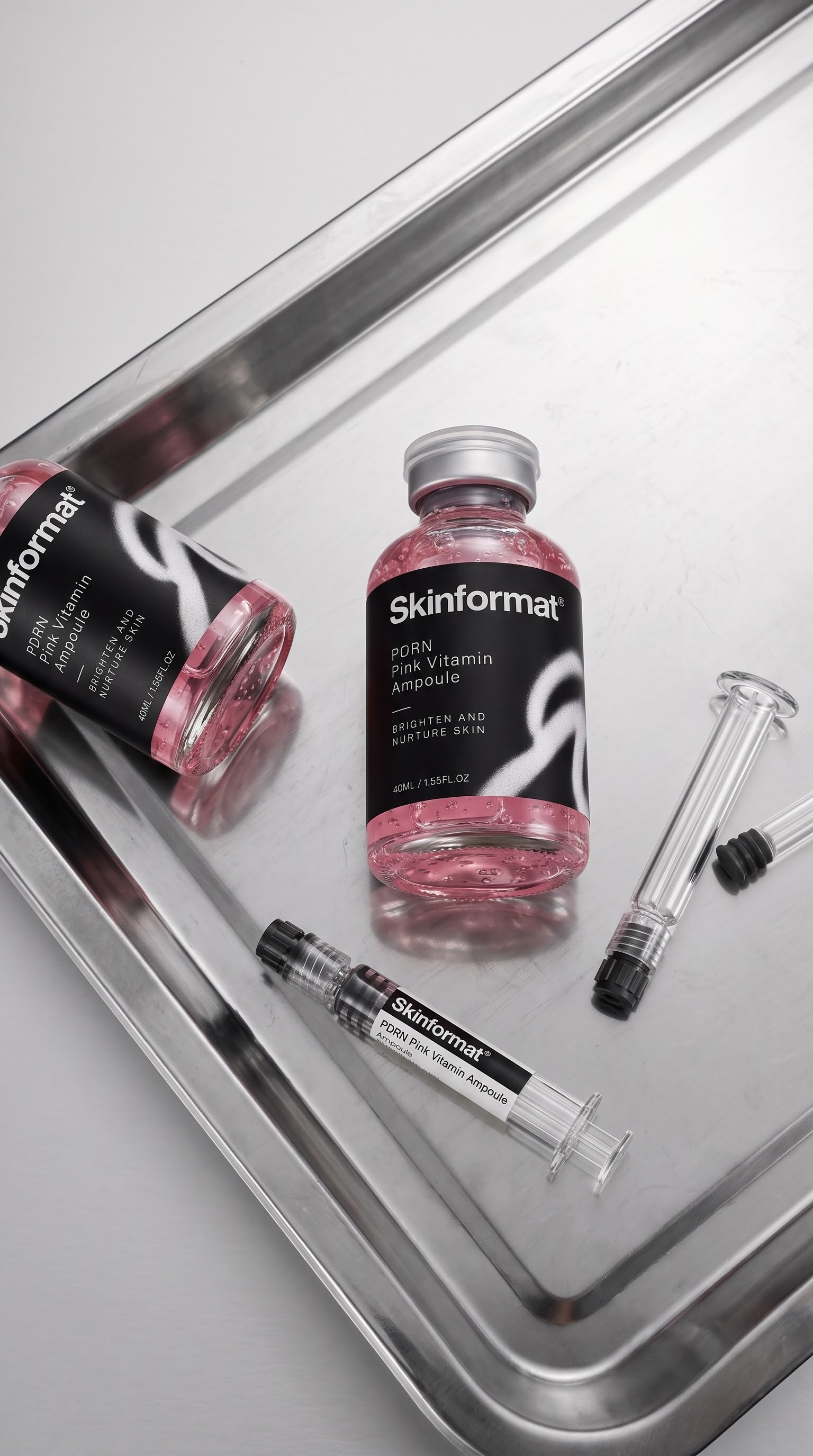 Skinformat Pink Vitamin Ampoules and serum applicators on a silver tray